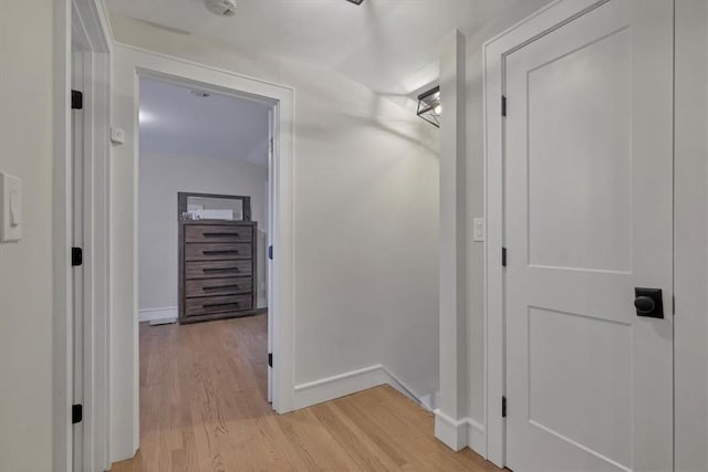 hallway with light hardwood / wood-style flooring