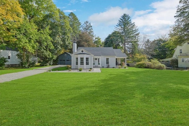 back of property featuring a garage and a yard