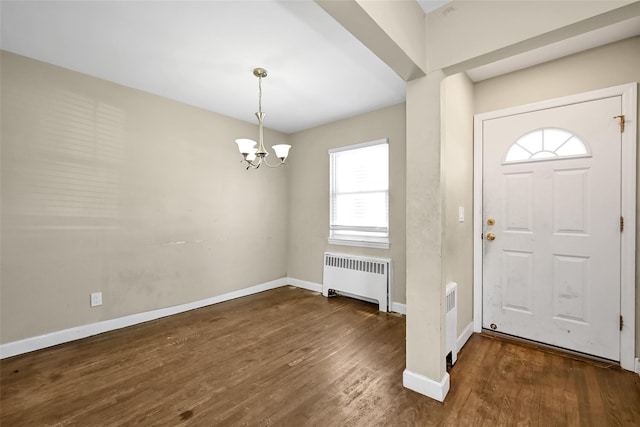 foyer featuring a chandelier, dark hardwood / wood-style flooring, and radiator