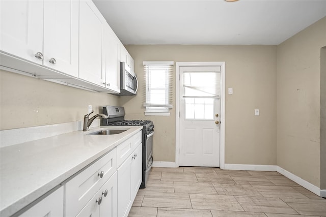 kitchen with white cabinetry, appliances with stainless steel finishes, and sink