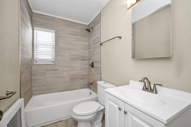 full bathroom featuring tiled shower / bath, vanity, and toilet