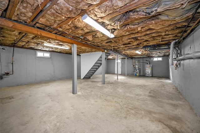 basement with gas water heater and a healthy amount of sunlight