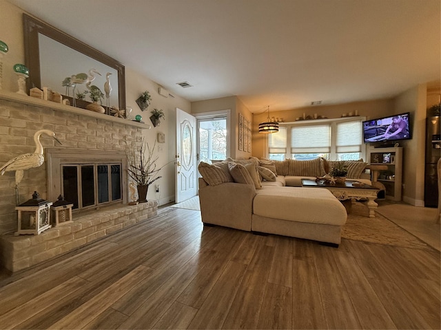 living room with hardwood / wood-style flooring and a fireplace