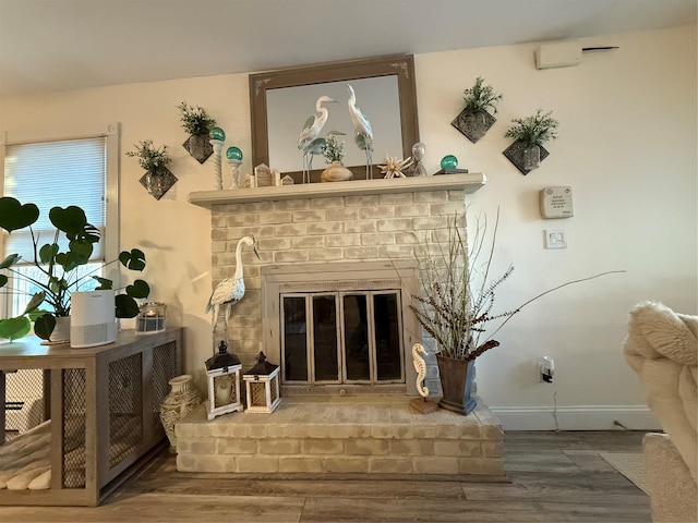 interior details with wood-type flooring and a fireplace