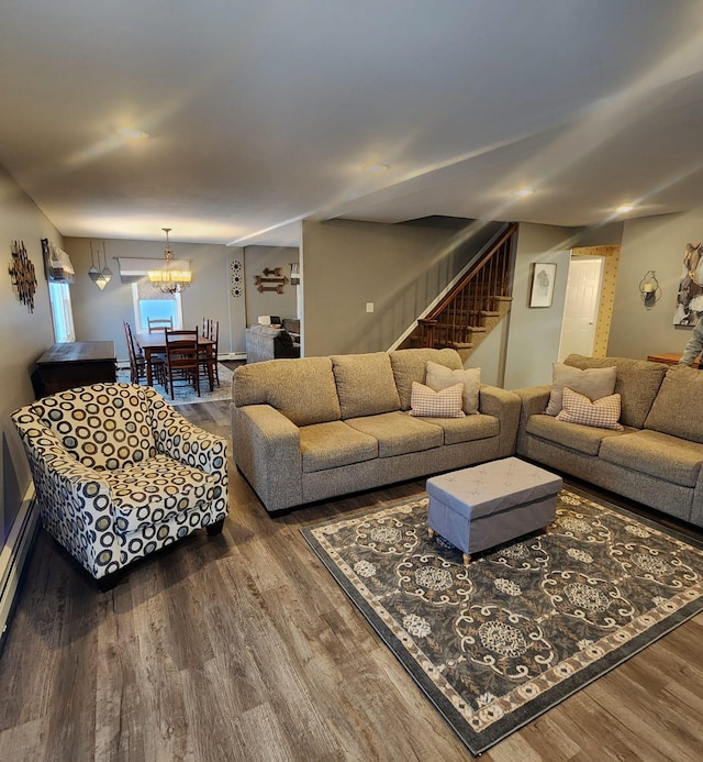 living room featuring an inviting chandelier and dark hardwood / wood-style flooring