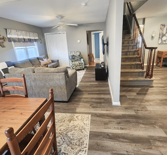 living room featuring ceiling fan and dark hardwood / wood-style flooring