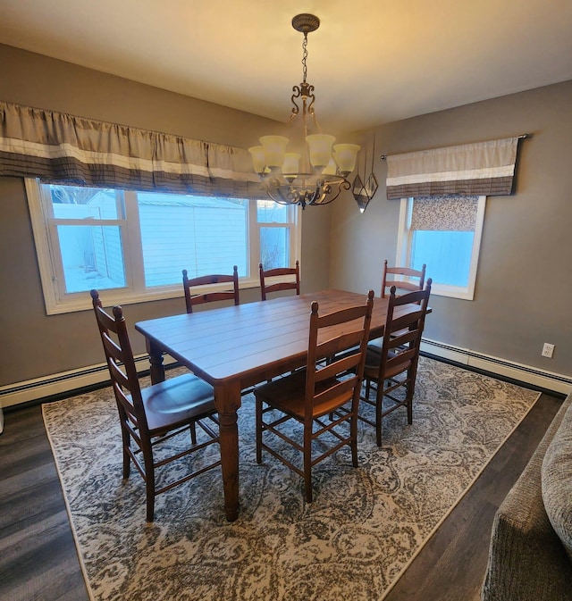 dining space featuring an inviting chandelier, a baseboard heating unit, and dark hardwood / wood-style floors