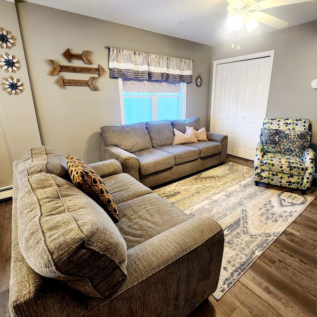 living room with ceiling fan, wood-type flooring, and a baseboard radiator