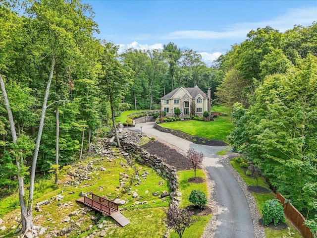 view of property's community with a lawn