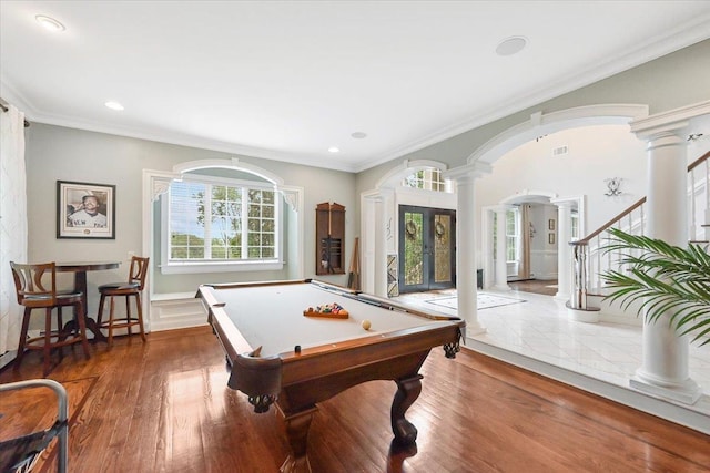 game room featuring hardwood / wood-style flooring, pool table, ornamental molding, and ornate columns