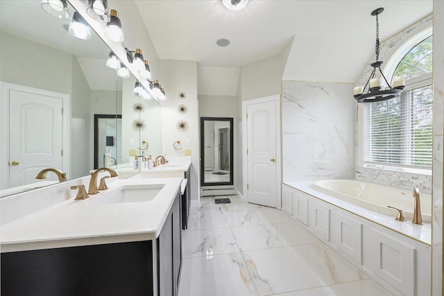 bathroom featuring vanity, a washtub, and lofted ceiling