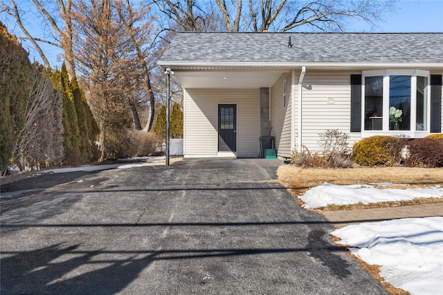 property entrance with a carport