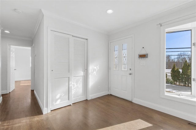 entryway with crown molding and dark hardwood / wood-style floors