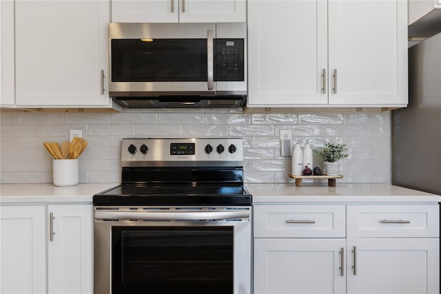 kitchen featuring tasteful backsplash, appliances with stainless steel finishes, and white cabinets