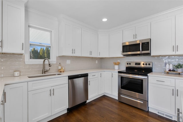 kitchen with white cabinetry, sink, tasteful backsplash, and stainless steel appliances