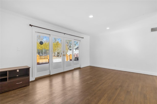 unfurnished room with ornamental molding, dark hardwood / wood-style flooring, and french doors