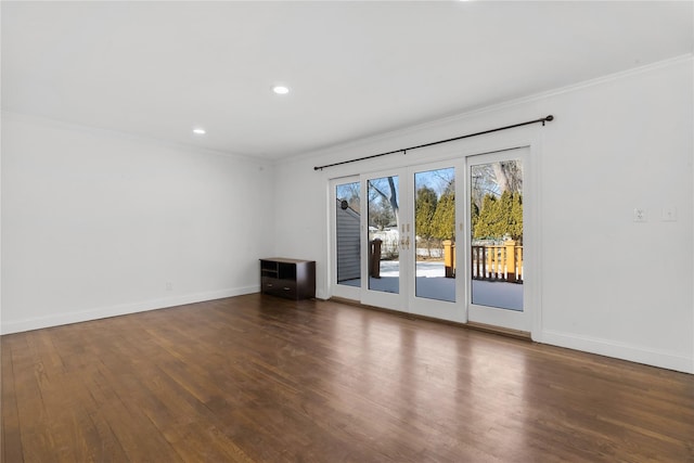 unfurnished living room with crown molding and dark hardwood / wood-style flooring