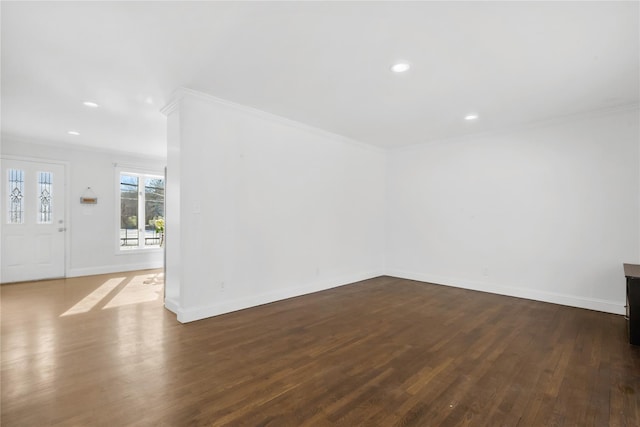 unfurnished room featuring dark hardwood / wood-style flooring and crown molding