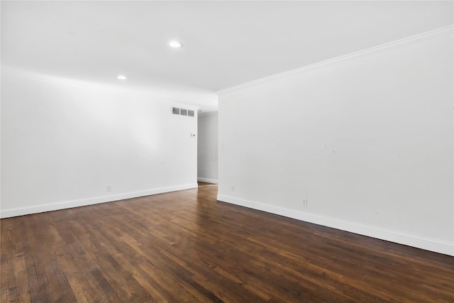 unfurnished room with ornamental molding and dark hardwood / wood-style flooring