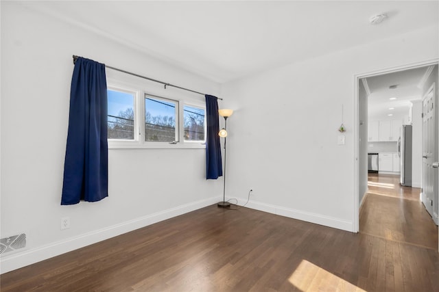 empty room featuring dark hardwood / wood-style flooring