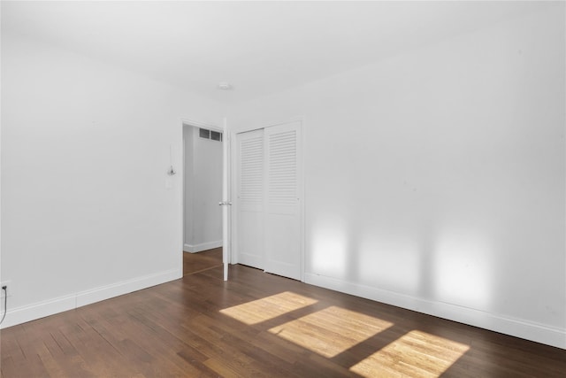 unfurnished room featuring dark hardwood / wood-style floors