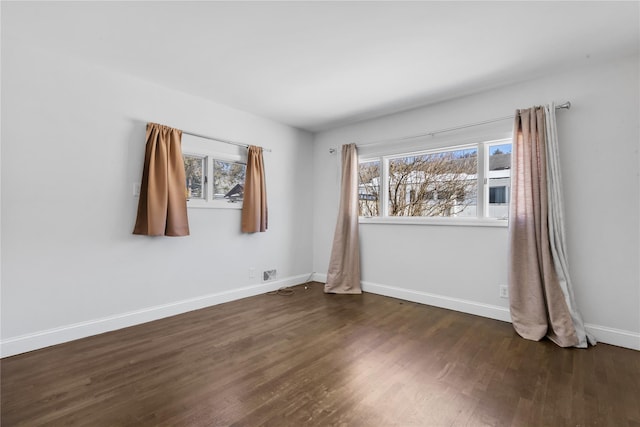 unfurnished room with a healthy amount of sunlight and dark hardwood / wood-style floors