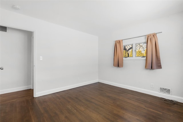 unfurnished room with dark hardwood / wood-style flooring