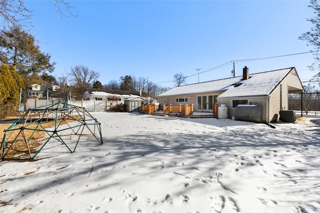 yard covered in snow featuring a trampoline