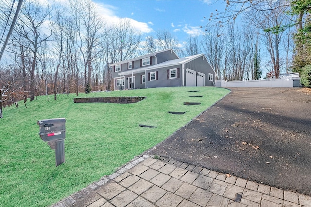 view of front of property featuring a garage and a front lawn