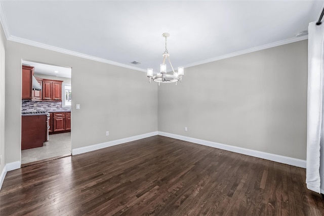 unfurnished dining area featuring an inviting chandelier, crown molding, and wood-type flooring