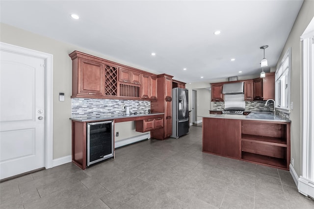 kitchen featuring baseboard heating, hanging light fixtures, wine cooler, stainless steel fridge with ice dispenser, and kitchen peninsula