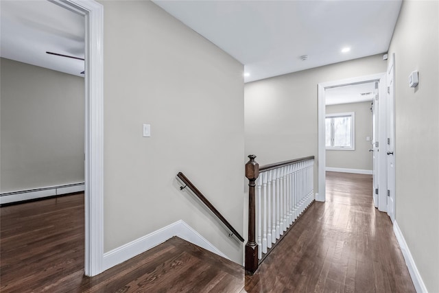 staircase featuring a baseboard radiator and hardwood / wood-style floors