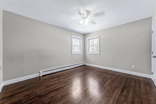 spare room with baseboard heating, ceiling fan, and dark wood-type flooring