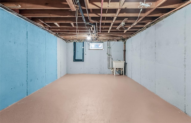 basement with sink and electric panel