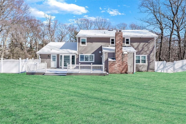 rear view of property featuring a wooden deck and a yard