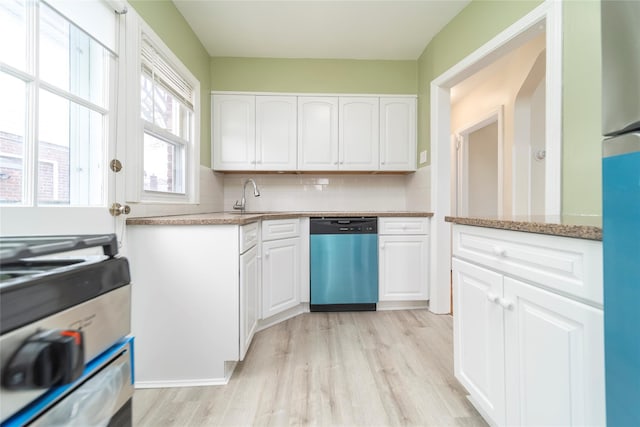 kitchen with backsplash, appliances with stainless steel finishes, light stone countertops, and white cabinets