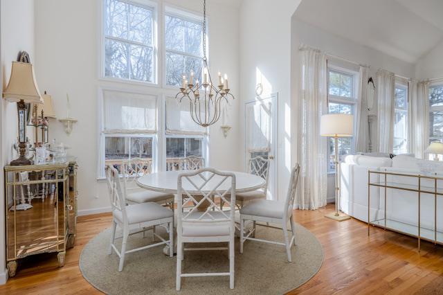 dining area with high vaulted ceiling, a chandelier, plenty of natural light, and light hardwood / wood-style flooring