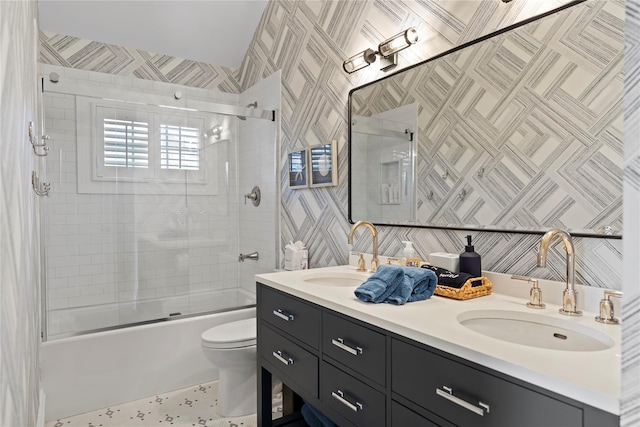 full bathroom with vanity, shower / bath combination with glass door, and toilet