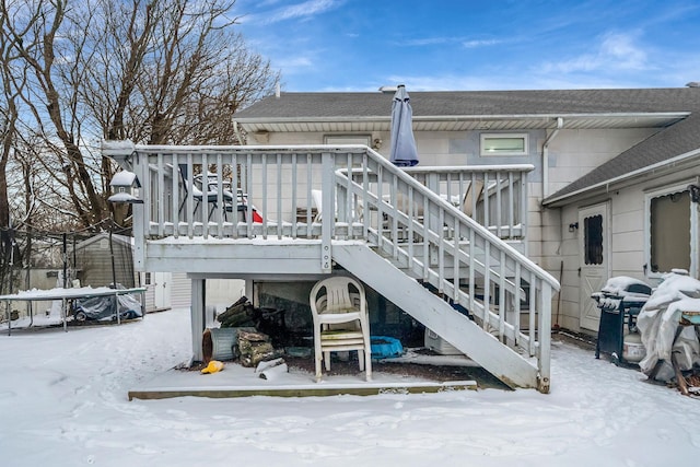 snow covered rear of property featuring a wooden deck