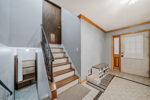 tiled entryway featuring crown molding