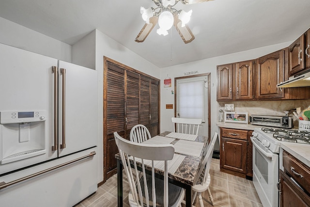 kitchen with ceiling fan, dark brown cabinets, and white appliances