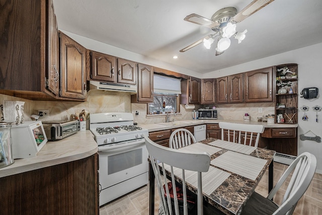 kitchen with ceiling fan, dark brown cabinets, sink, and white appliances