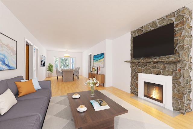 living room featuring a stone fireplace and hardwood / wood-style floors