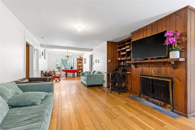 living room featuring light hardwood / wood-style floors and a notable chandelier