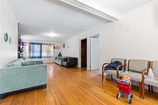 living room with crown molding and light hardwood / wood-style flooring