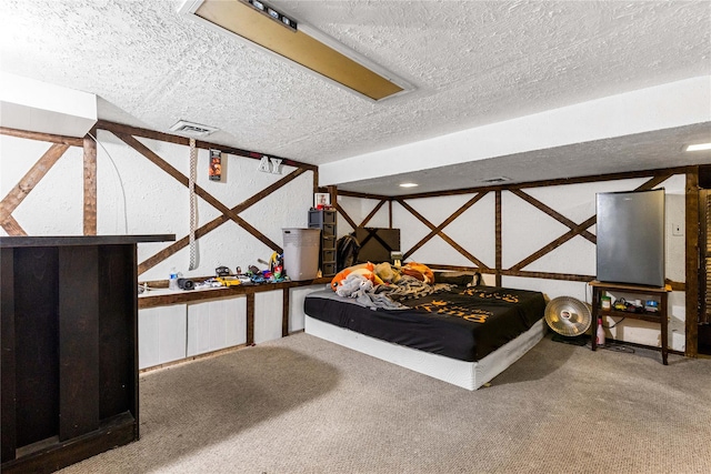 carpeted bedroom featuring a textured ceiling