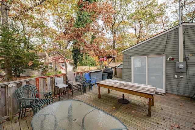 wooden terrace featuring a grill