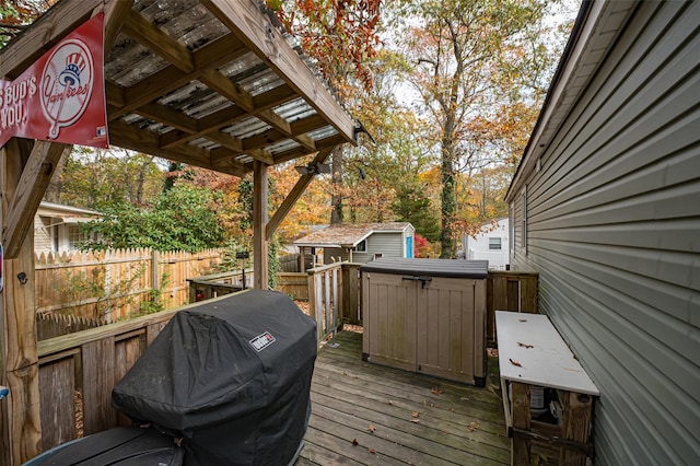 wooden deck featuring a storage unit