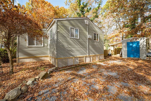 view of side of home featuring a storage shed