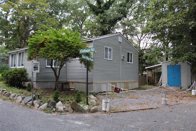 view of side of property featuring a storage unit